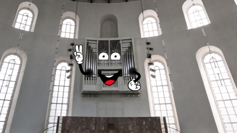 Olga, die Orgel Die Orgel an der Wand der Paulskirche mit digitalen Cartoon Elementen verziert, sodass sie ein lachendes Gesicht und Hände hat. Sie macht ein Peacezeichen.