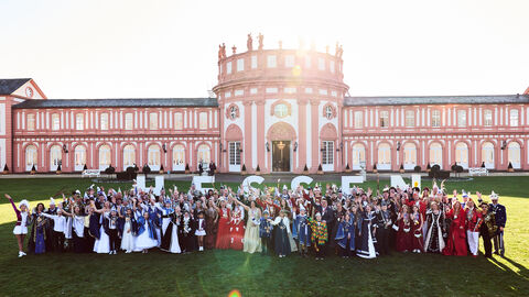 Ministerpräsident Rhein empfängt hessische Tollitäten im Biebricher Schloss Boris Rhein steht mit den hessischen Tollitäten vorm Biebricher Schloss. Sie halten Buchstaben in die Höhe, die das Wort "Hessen" ergeben.